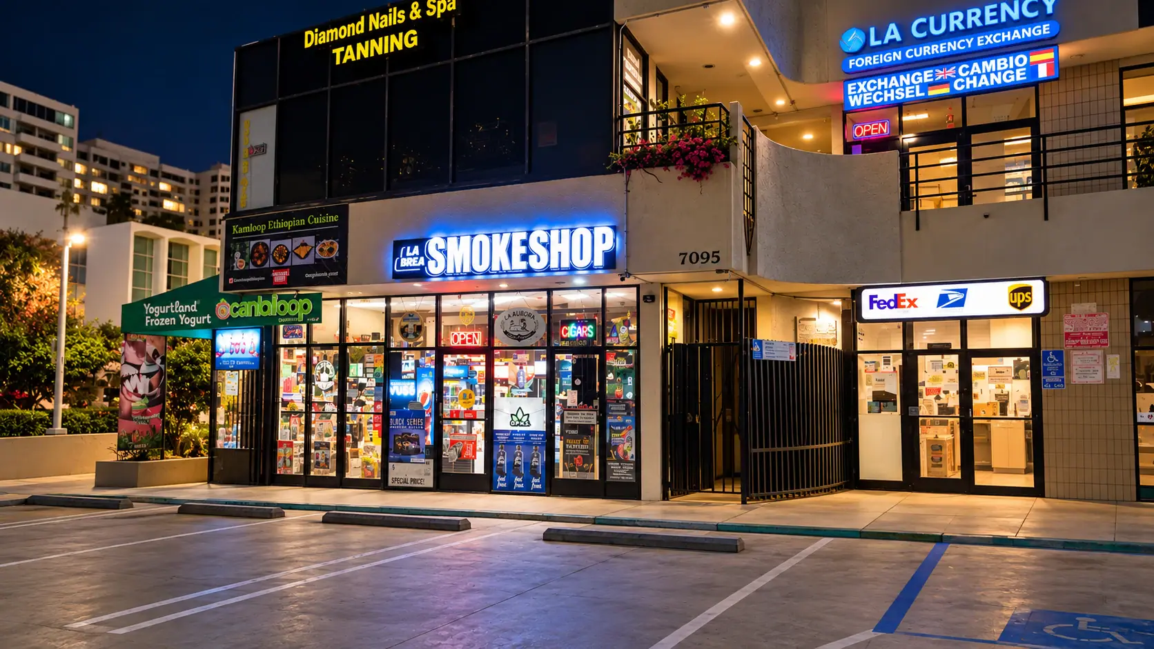 La Brea Smoke Shop at night, its blue neon sign lit above the windows, in the plaza at 7095 Hollywood Blvd with parking in front
